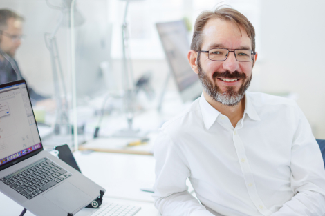 David Adams, profile picture sitting at desk